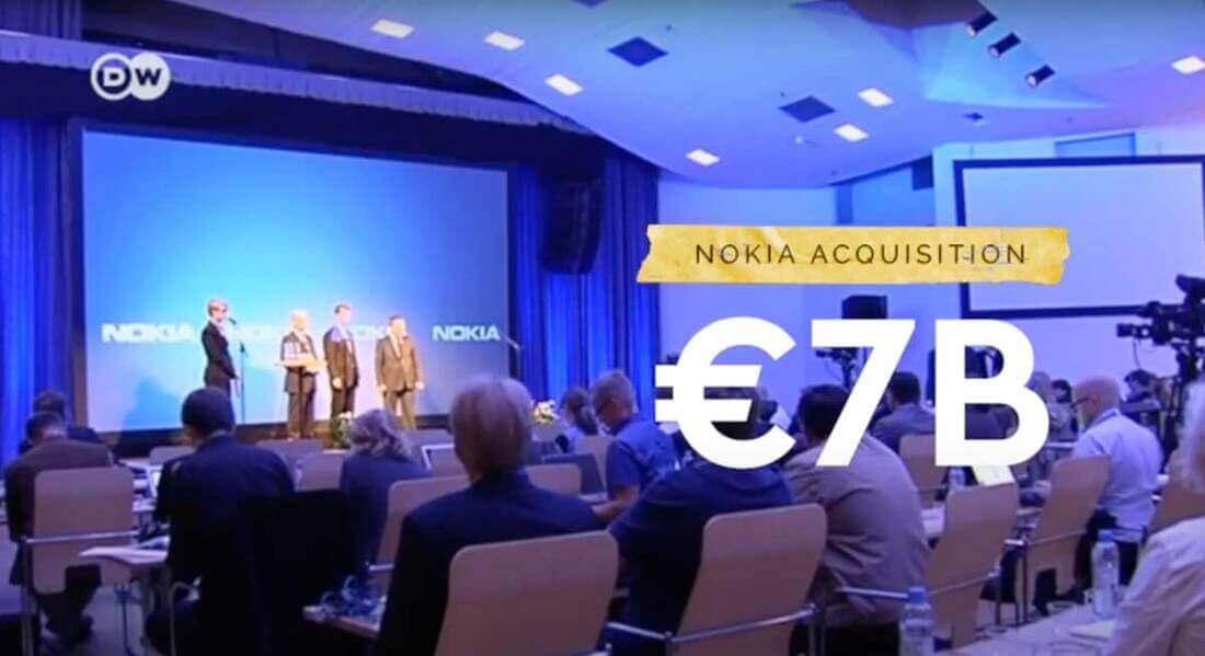 Image for: Why Microsoft acquired Nokia: a Nokia conference shows several speakers on the stage, with the words Nokia acquisition, and 7 billion Euros on the right