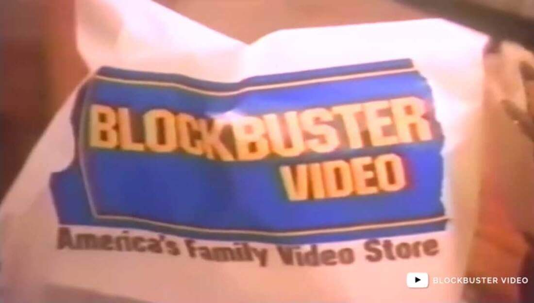 Image for What Happened to Blockbuster: a still from an ad that shows a delivery back with the Blockbuster logo